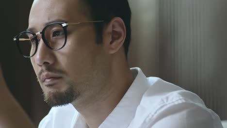 portrait of bearded asian designer contemplating with model in hand