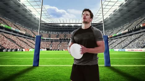 serious rugby player holds rugby ball