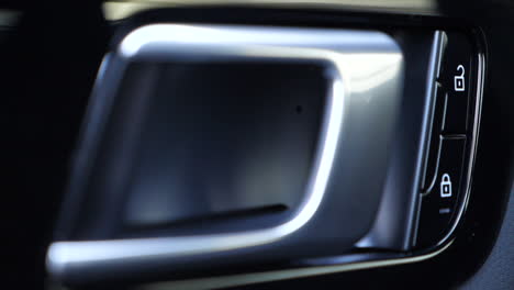 Close-up-of-door-handle-and-lock-buttons-of-a-car
