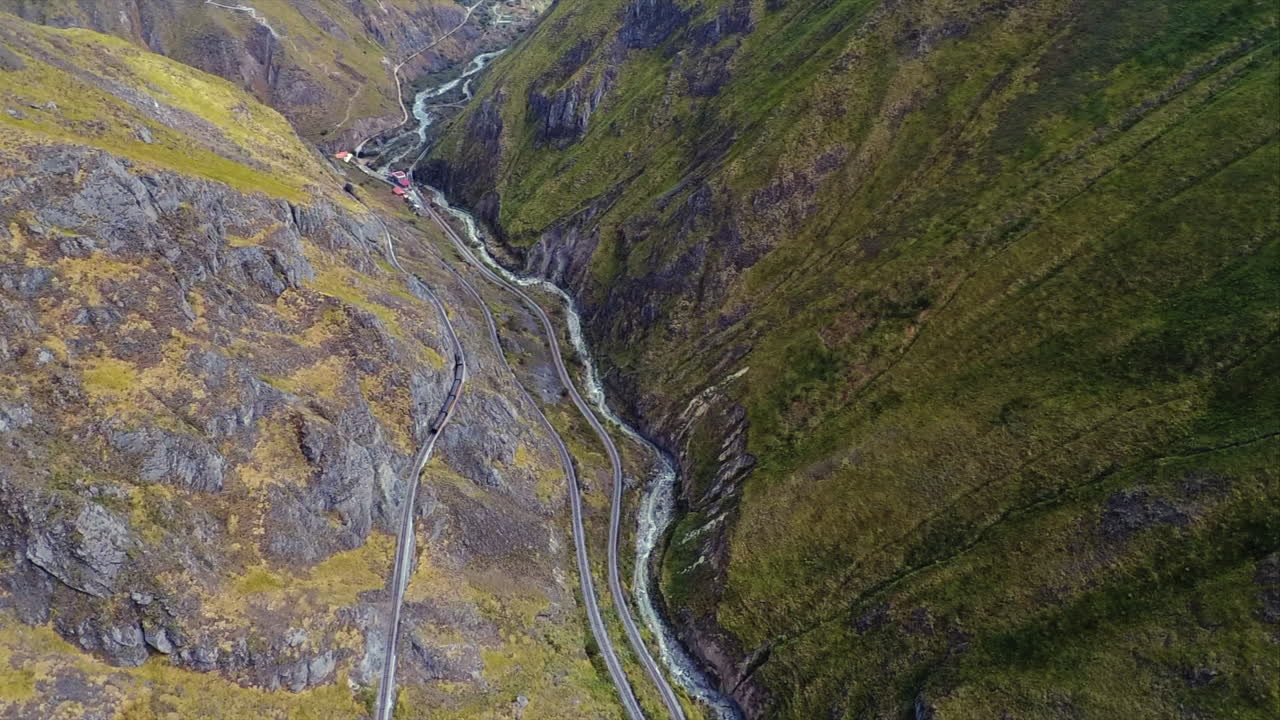 una toma aérea de un tren dando la vuelta a la "nariz del diablo" o la nariz del diablo en alausí, provincia de chimborazo, ecuador