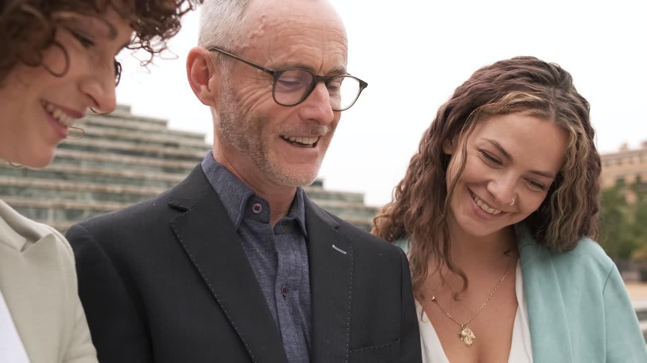 Happy business people discussing ideas near steps in city