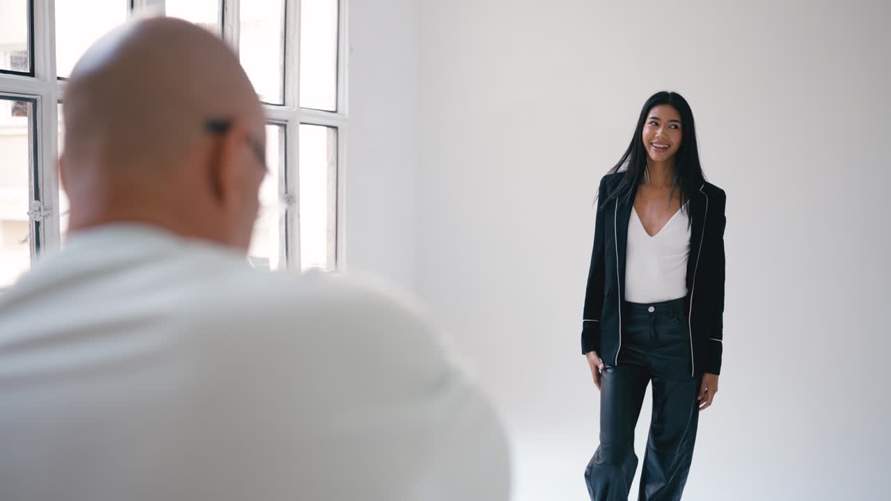 A woman posing in a white studio