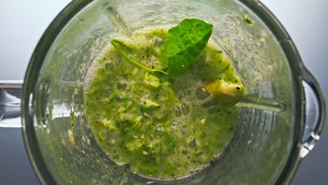 top view vegetable cocktail preparing in blender super slow motion close up.