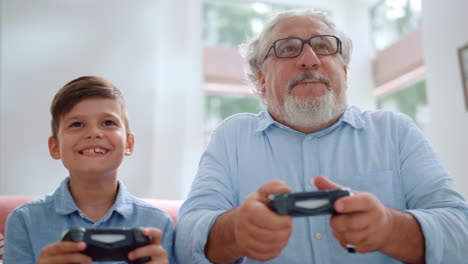 Grandfather-playing-video-game-with-grandson.-Mature-man-and-boy-using-joysticks