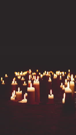 multiple lit candles illuminating the darkness