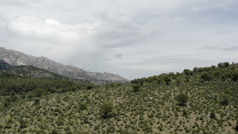 aerial drone pull out over the sierra de guadarrama mountain range revealing this epic spanish landscape