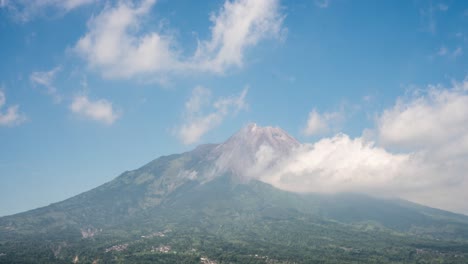 Wispy-clouds-holding-on-the-edges-of-mount-Merapi,-Java,-Indonesia