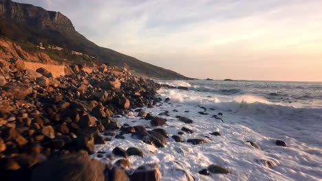 wild surf with foamy white spray on stony coast line