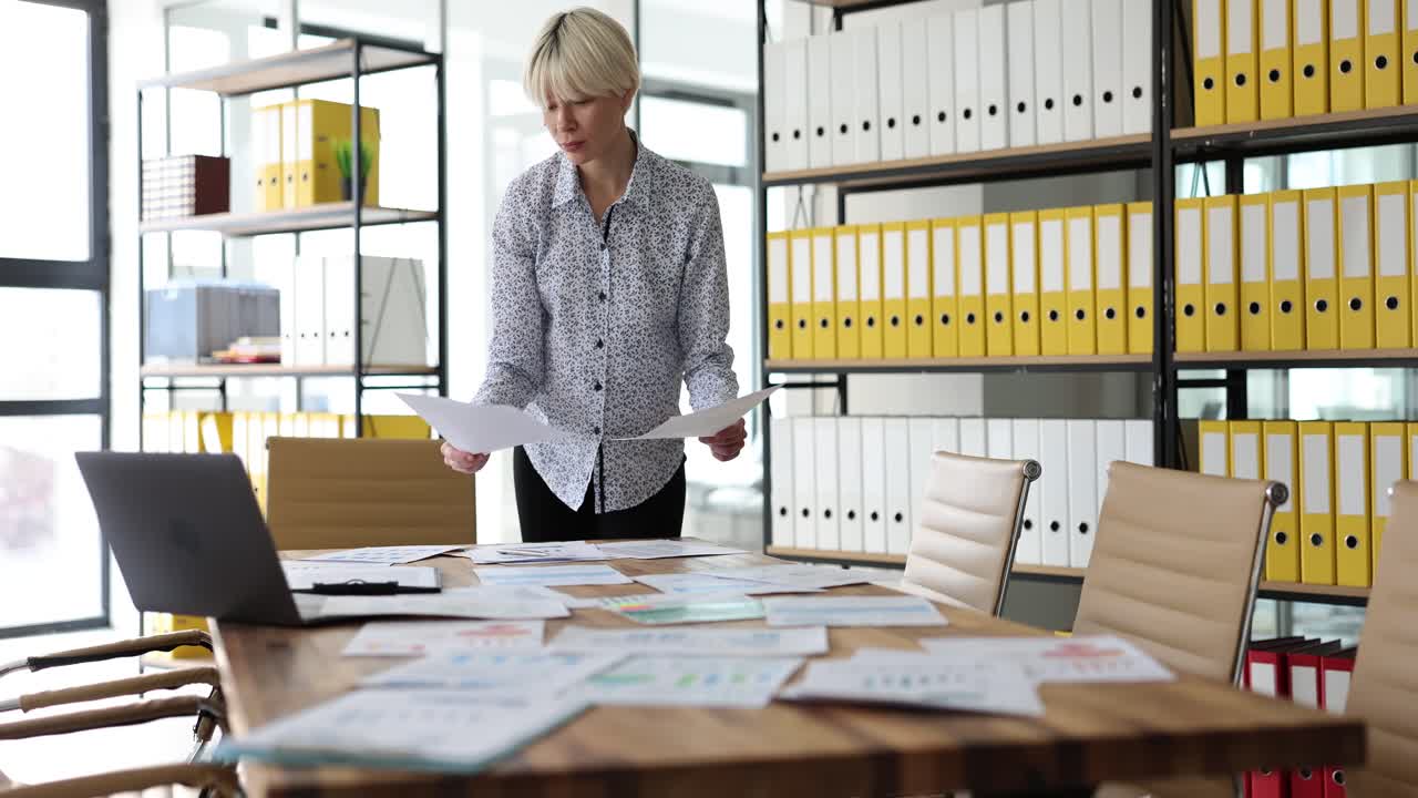Businesswoman Analyzing Documents and Data in an Office Meeting Room