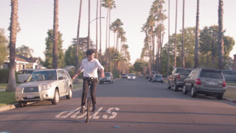 man riding a unicycle on a suburban street
