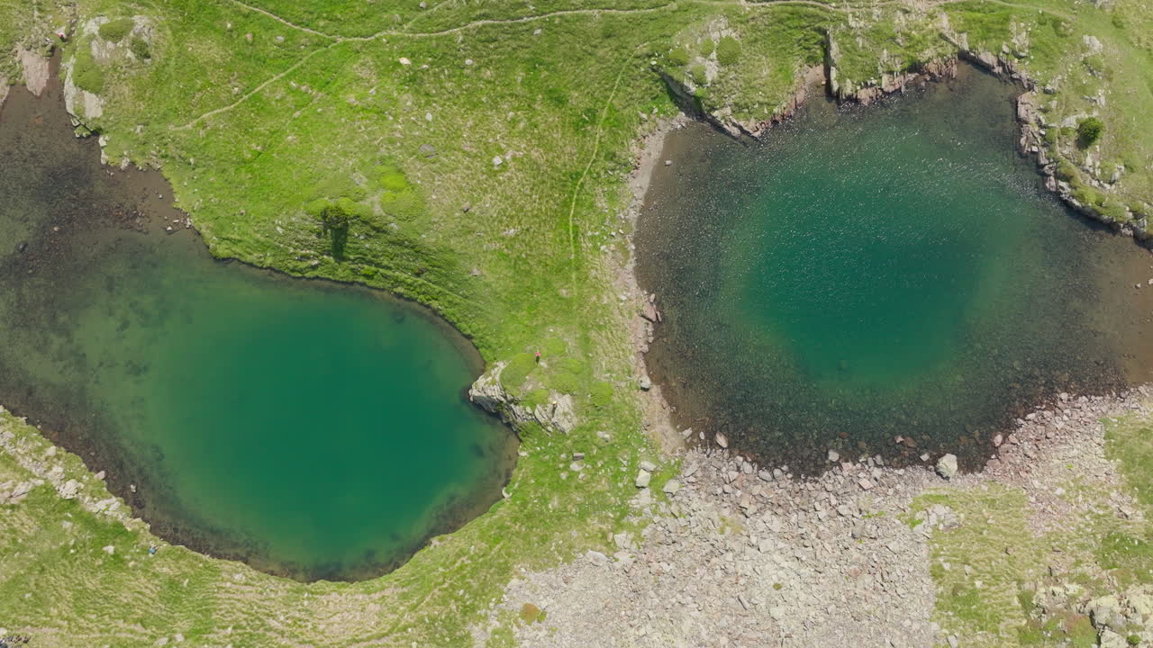 A couple walking across two lakes