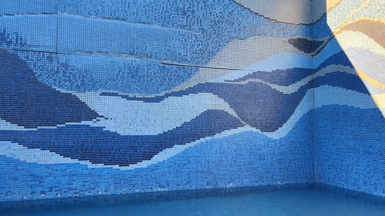 Abstract wave pattern no action present, in indoor possibly a pool or water feature, with waves, water surface, with glass tiles with wave texture, from a top-down perspective perspective.