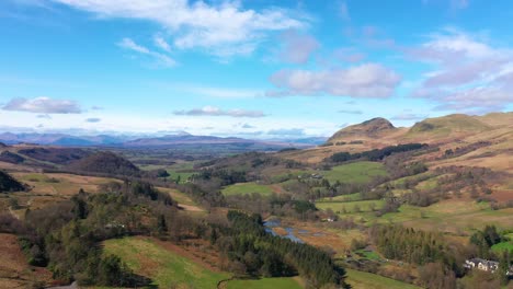 beautiful countryside in scotland, aerial view of village in scottish landscape, green nature and mountains