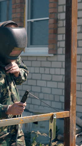 welder working on a metal fence