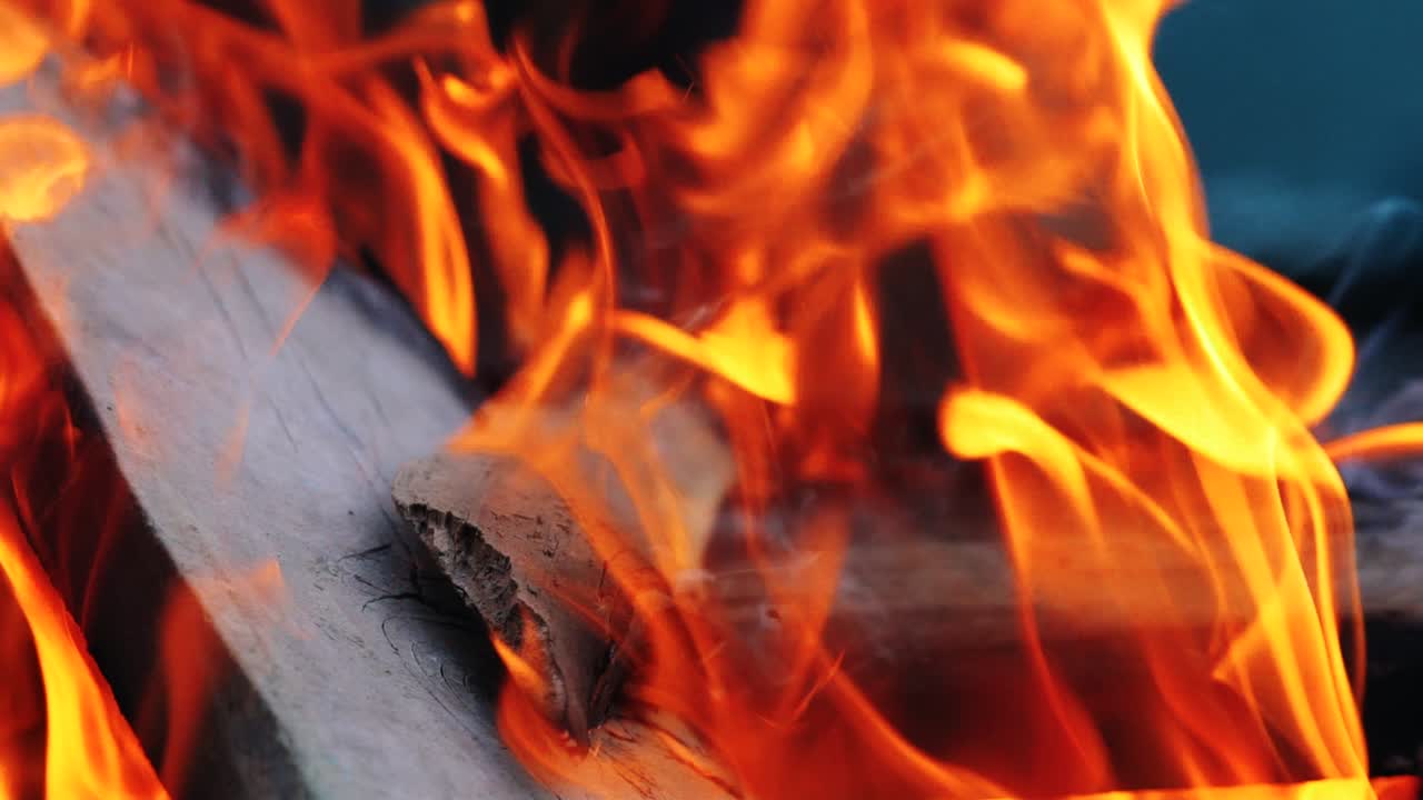 tongue of the flame are enveloping the wooden boards