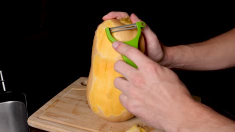 Locked-Off-View-Of-Peeling-Skin-Off-Butternut-Pumpkin-With-Vegetable-Peeler