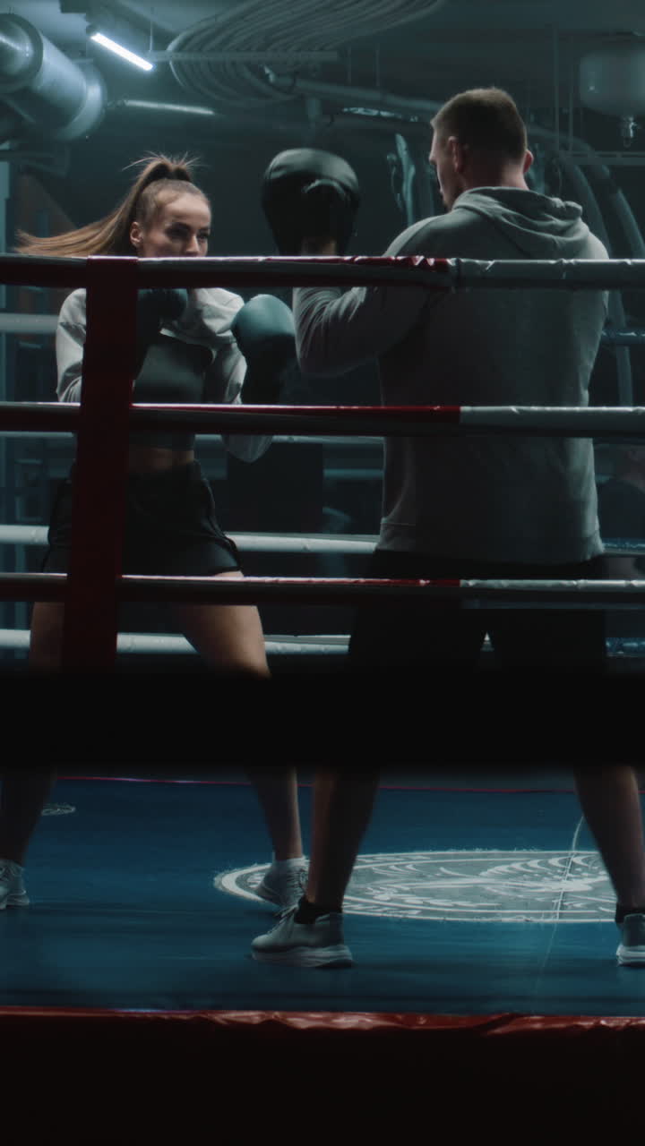 Female Boxer Training with Coach in Boxing Ring