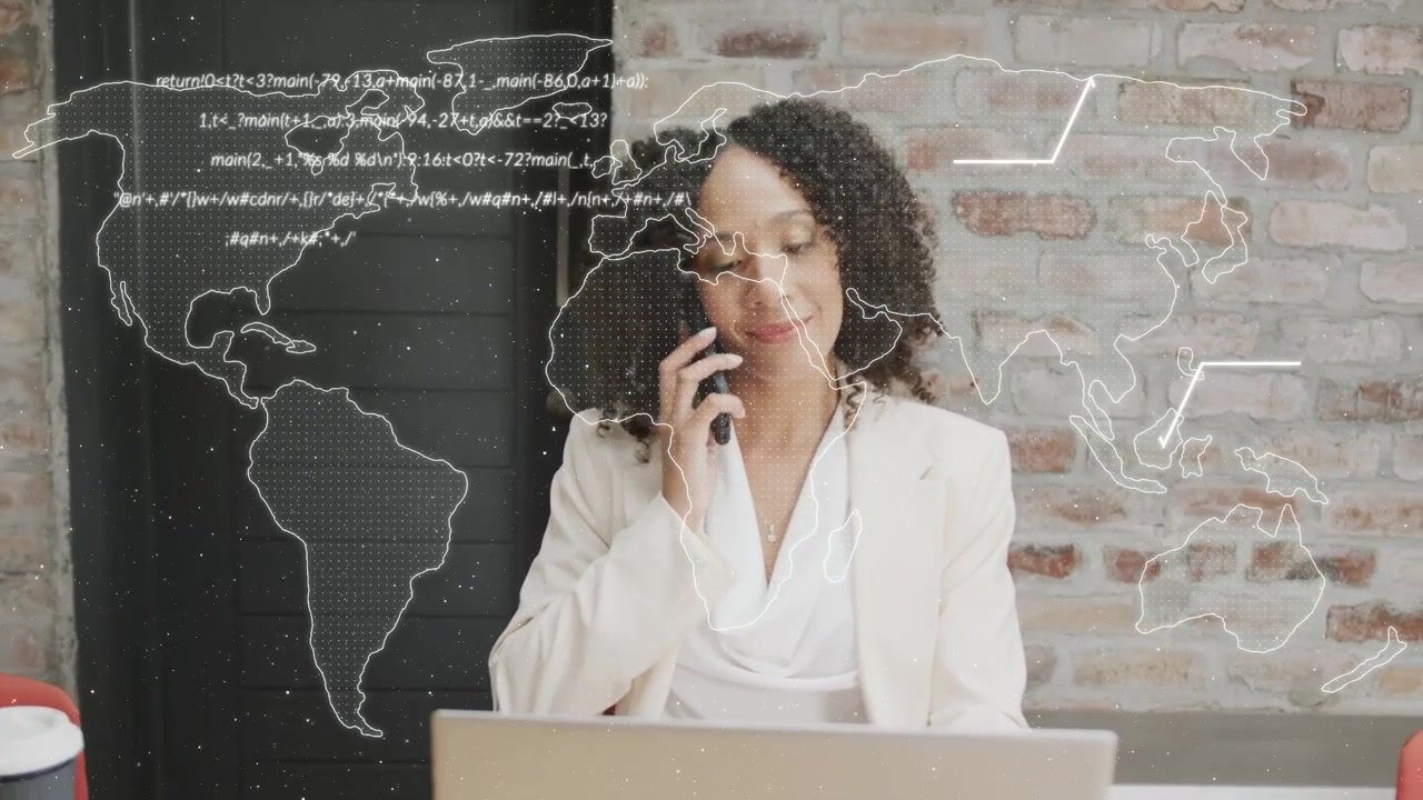 Woman at desk picking phone taking tech call while switching devices with world map or code overlayi