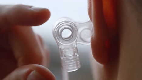 close-up of a clear earplug or hearing aid in a person's ear