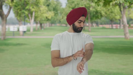 confident sikh indian man getting ready in park