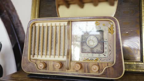 closeup detail of old wooden table clock reflecting the light from a window