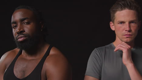retrato de estudio de cerca de atletas masculinos serios y decididos entrenando en ropa de fitness disparado contra un fondo negro