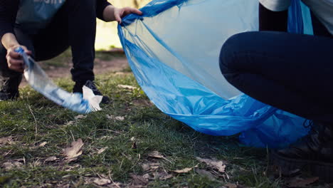 team of activists collecting rubbish and plastic waste to recycle