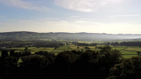 Misty-rural-countryside-sunrise-over-trees-view-across-North-Wales-farming-landscape