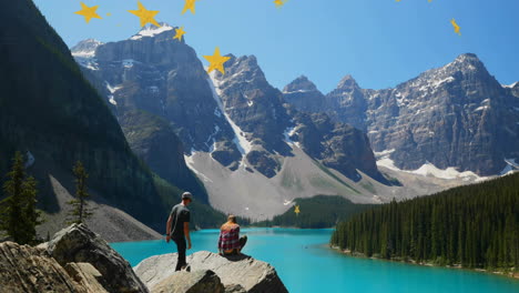 man standing and woman crouching on rock by lake, technology interface displaying geography data