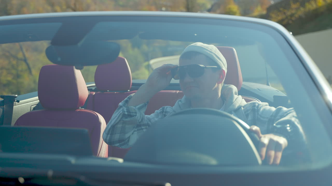 경치 좋은 경로 에서 컨버터블 자동차 를 운전 하는 사람