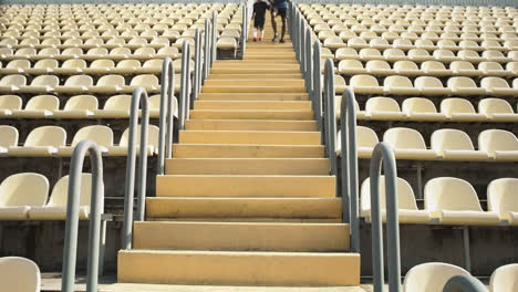 father and son running up stadium stairs