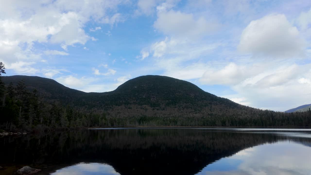 Calm water mirrors mountain and trees at Desolation Lake in morning light