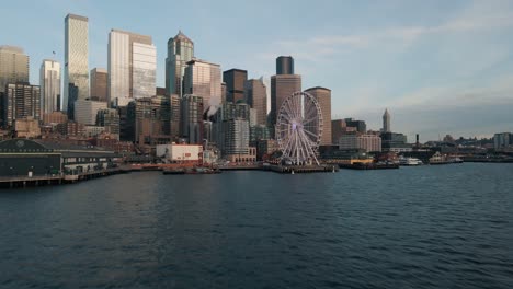 cinematic establishing shot above seattle waterfront reveals picturesque buildings reflecting cloudy sky