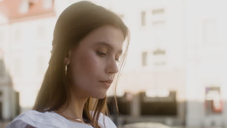 close-up view of young fashionable woman sitting outdoors