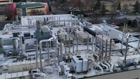 aerial shot of steam and smoke fuming out of steel hvac appliances on lab