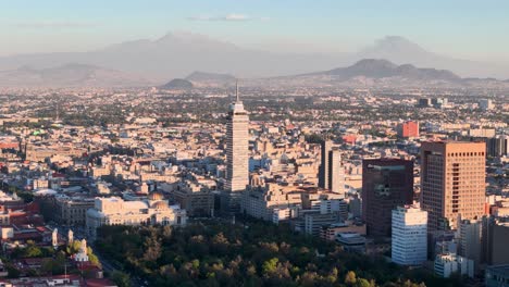 Drone-shot-of-bellas-artes-palace-and-volcanoes-in-mexico-city