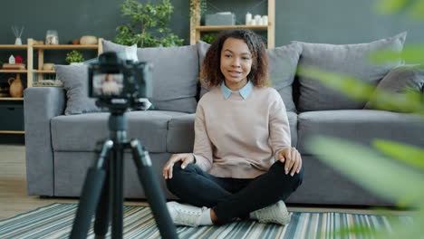 young woman recording a vlog at home