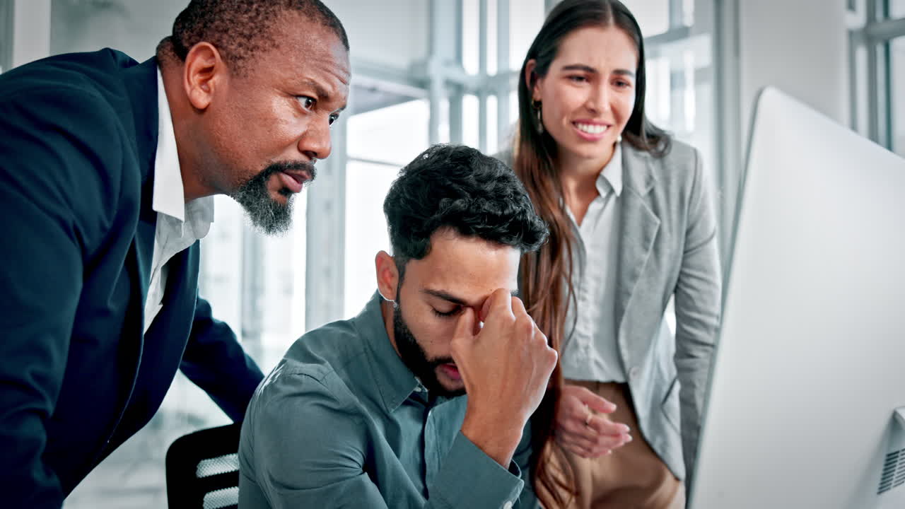 Business Colleagues Experience Stress While Working on Computer in Office