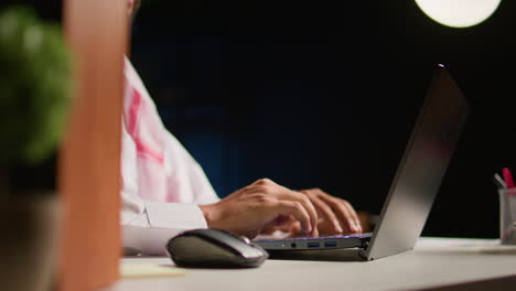 man typing on laptop, surfing internet