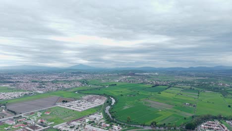 aerial view of a city, after rain, green fields