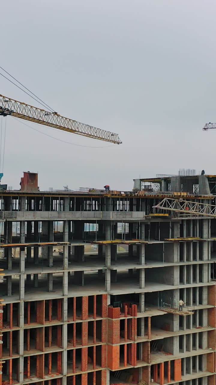 Construction of a residential apartment complex. Aerial view. Vertical video