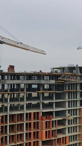 construction of a residential apartment complex. aerial view. vertical video