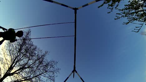 A-slow-motion-clip-of-a-father-pushing-his-son-on-a-swing