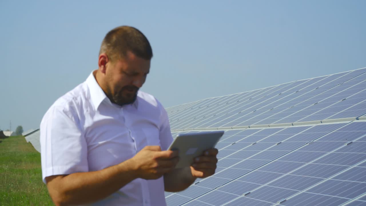 Male taking picture of the back side of solar panel