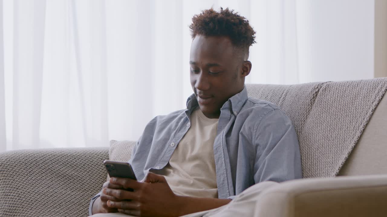 Man Using Smartphone on Couch