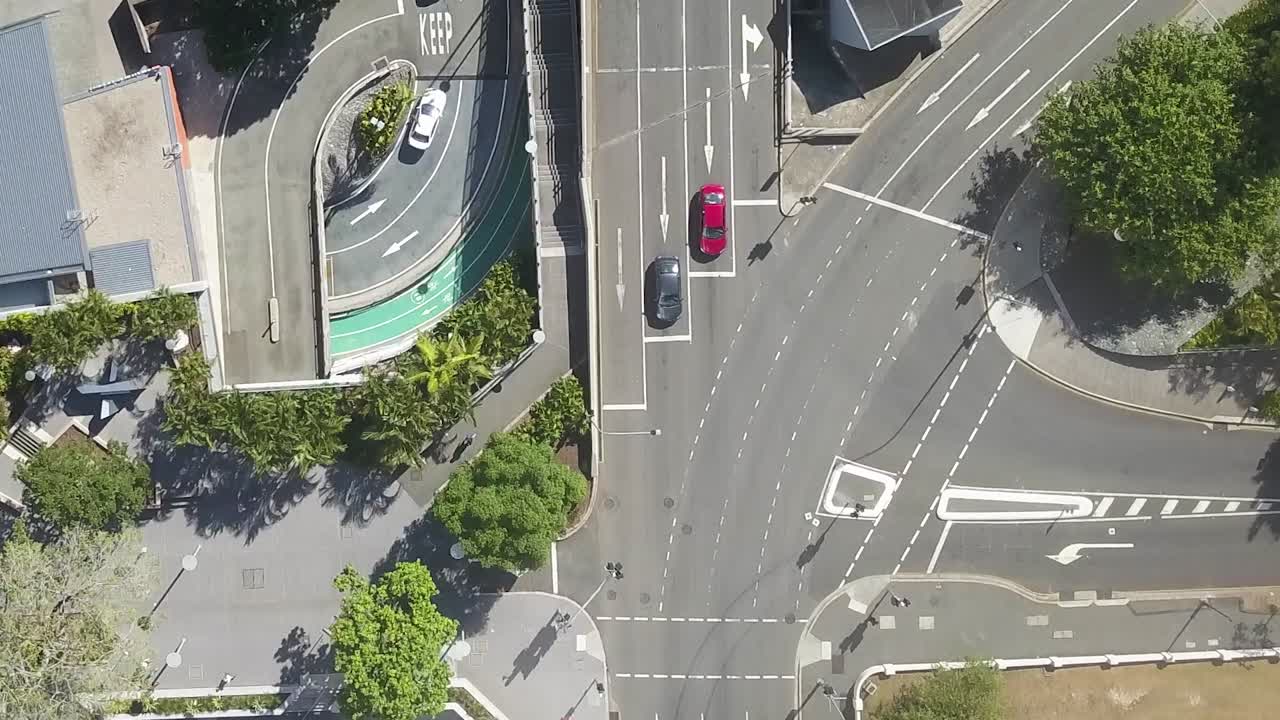 Drone bird's eye view above pedestrians crossing street intersection in city