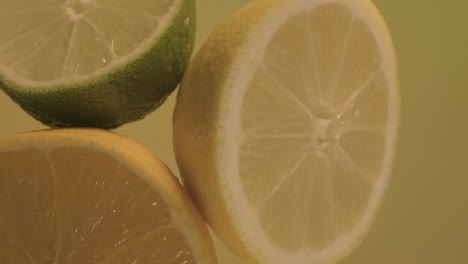jugosas mitades de lima limón y naranja, cítricos girando a cámara lenta