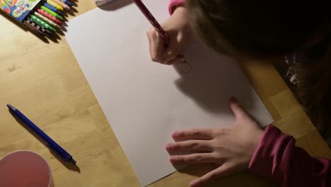 close up of kid child female girl drawing on paper during art class learning new skill