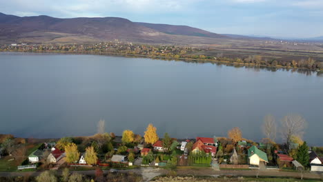 flyover drone shot of a small village by the lakeside