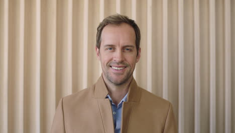 portrait-of-handsome-casual-businessman-smiling-at-camera-confident-male-entrepreneur-enjoying-success